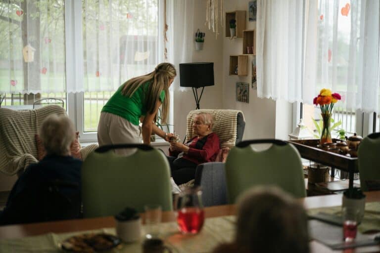 Senior resident getting assistance from a caregiver.